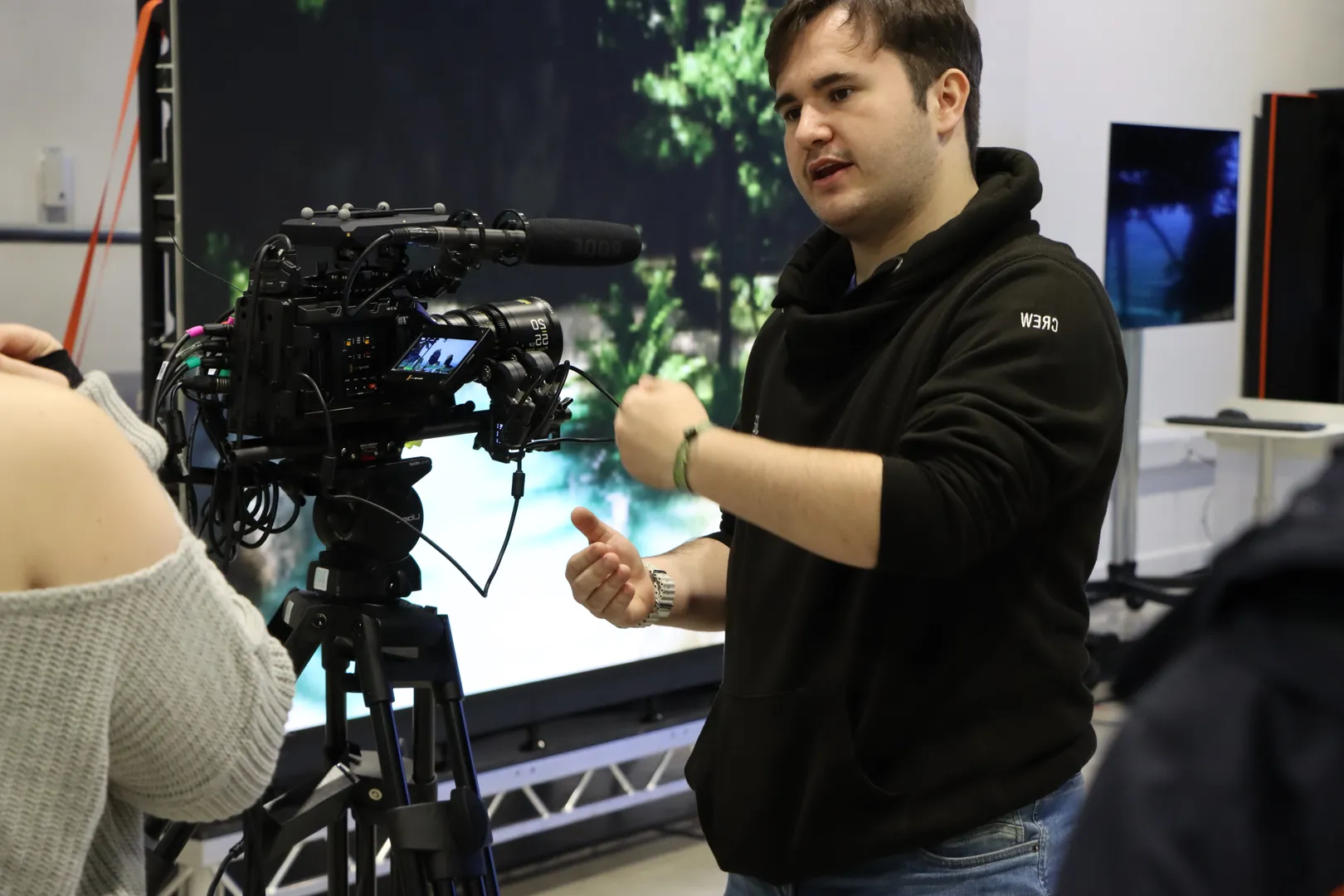Joshua Prasser gesturing and explaining virtual production techniques, including camera systems and LED screen workflows.